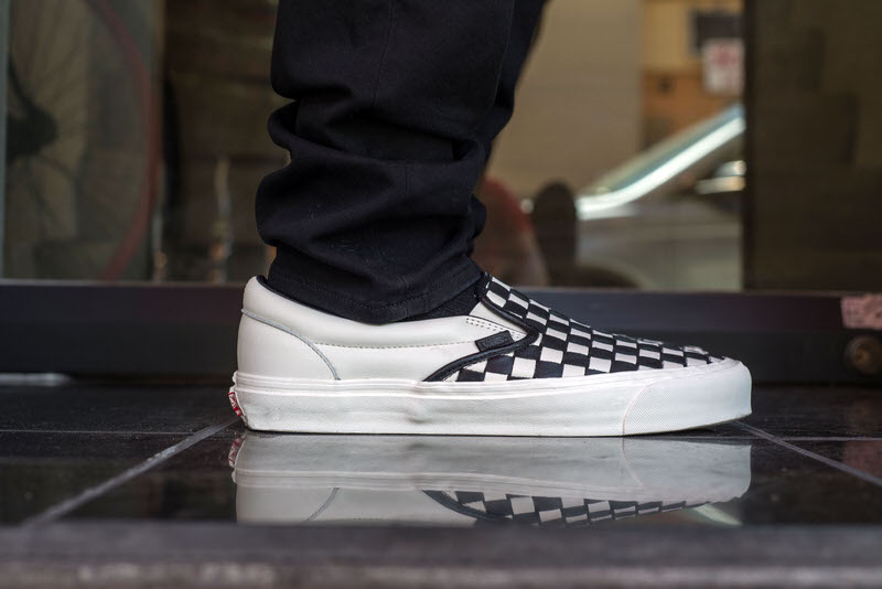 white slip on vans on feet