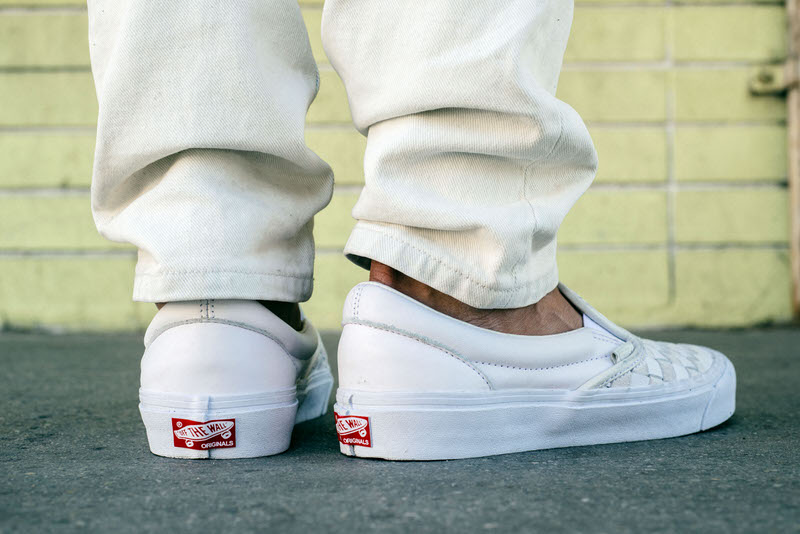 white vans slip ons on feet