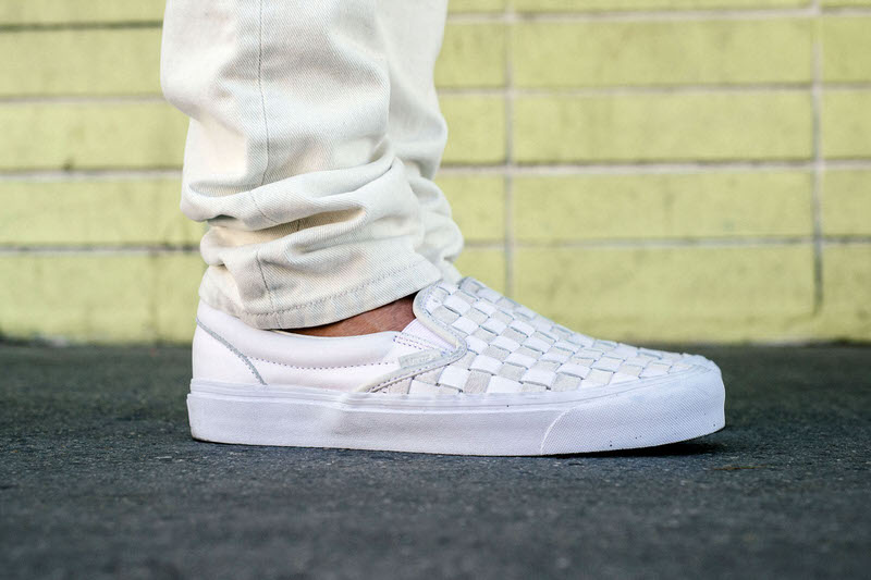 white slip on vans on feet