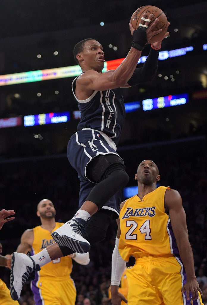 Dec 19, 2014; Los Angeles, CA, USA; Oklahoma City Thunder guard Russell Westbrook (0) shoots the ball in front of Los Angeles Lakers players Wesley Johnson (11) in the first quarter at Staples Center. Mandatory Credit: Kirby Lee-USA TODAY Sports