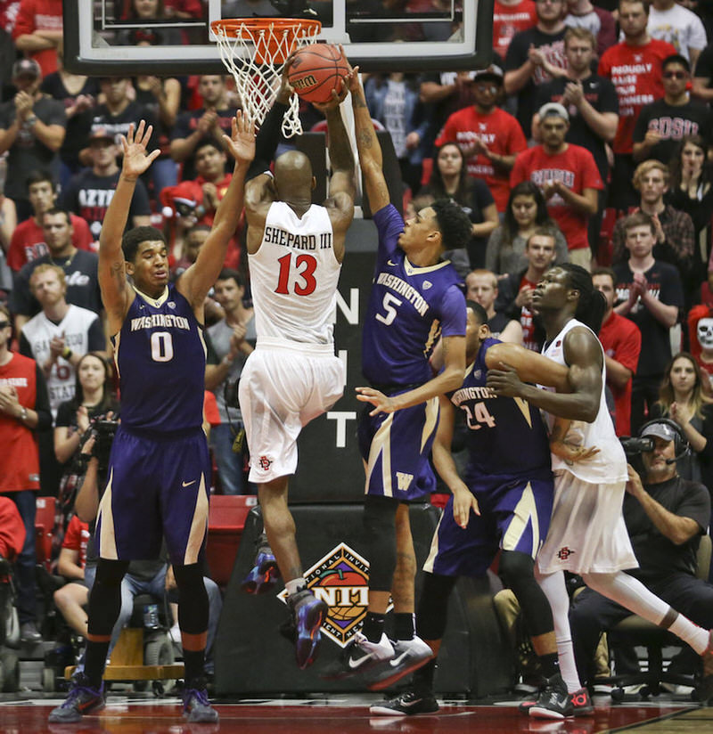 San Diego State forward Winston Shepard has hs shot blocked by Washington guard Dejounte Murray during the first half of an NIT college basketball game Monday, March 21, 2016, in San Diego. (AP Photo/Lenny Ignelzi)