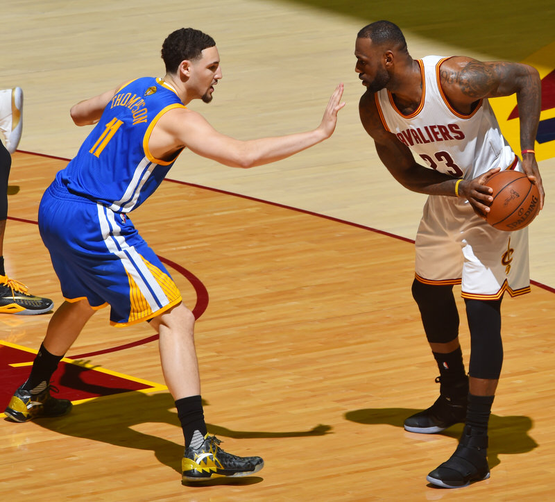 CLEVELAND, OH - JUNE 8: LeBron James #23 of the Cleveland Cavaliers handles the ball against Klay Thompson #11 of the Golden State Warriors in Game Three of the 2016 NBA Finals on June 8, 2016 at Quicken Loans Arena in Cleveland, Ohio. NOTE TO USER: User expressly acknowledges and agrees that, by downloading and/or using this Photograph, user is consenting to the terms and conditions of the Getty Images License Agreement. Mandatory Copyright Notice: Copyright 2016 NBAE (Photo by Jesse D. Garrabrant/NBAE via Getty Images)