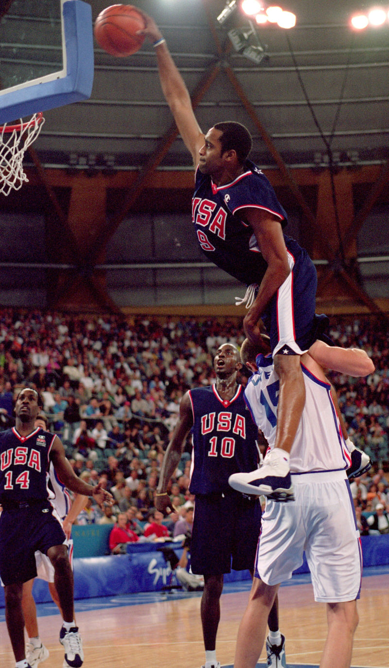 25 Sep 2000: Vince Carter of the USA leaps over Frederic Weis of France to dunk during the Mens Basketball Preliminaries at the Dome in the Olympic Park on Day 10 of the Sydney 2000 Olympic Games in Sydney, Australia. Mandatory Credit: Darren McNamara/Allsport