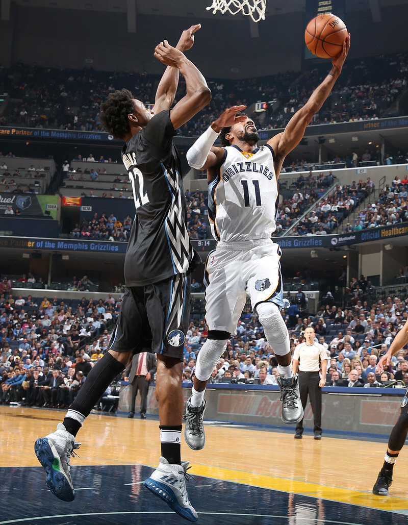 MEMPHIS, TN - OCTOBER 26:  Mike Conley #11 of the Memphis Grizzlies goes up for a lay up against Andrew Wiggins #22 of the Minnesota Timberwolves during a game on October 26, 2016 at FedExForum in Memphis, Tennessee. NOTE TO USER: User expressly acknowledges and agrees that, by downloading and or using this photograph, user is consenting to the terms and conditions of the Getty Images License Agreement. Mandatory Copyright Notice: Copyright 2016 NBAE (Photo by Joe Murphy/NBAE via Getty Images)