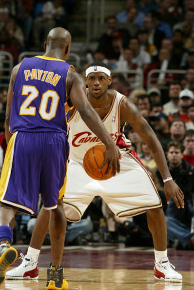 CLEVELAND - FEBRUARY 4: LeBron James #23 of the Cleveland Cavaliers stares down Gary Payton #20 of the Los Angeles Lakers February, 2004 at Gund Arena in Cleveland, Ohio. NOTE TO USER: User expressly acknowledges and agrees that, by downloading and or using this photograph, User is consenting to the terms and conditions of the Getty Images License Agreement. (Photo by David Liam Kyle/NBAE via Getty Images)