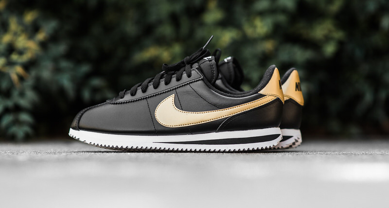 nike black & gold cortez suede trainers