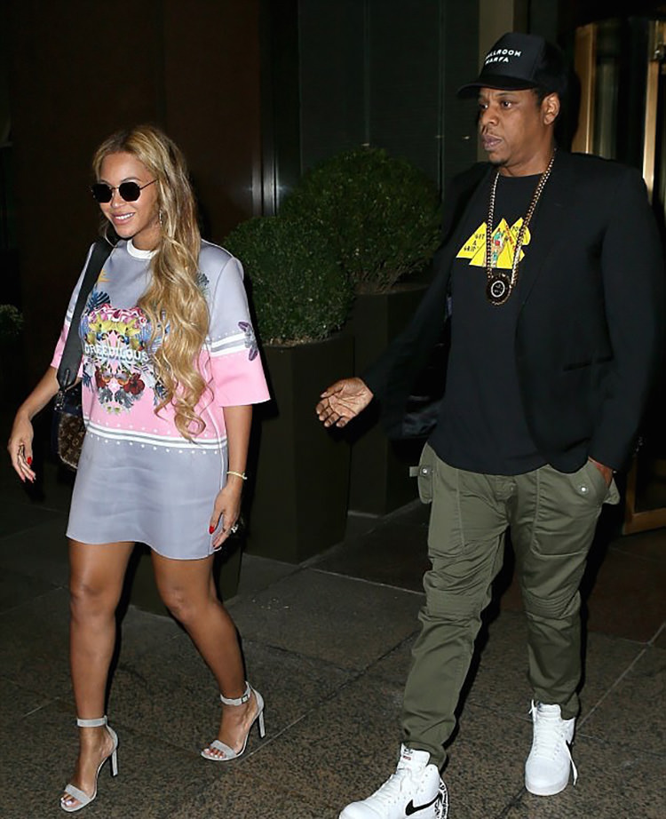 Jay Z styles fatigue pants and a graphic tee with the Supreme x Nike Air Force 1 High.