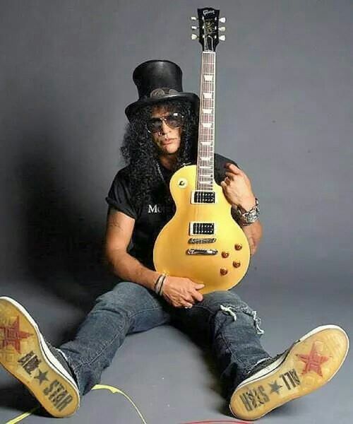 Three icons in one photo: Chuck Taylors, a Gibson guitar, and Slash.