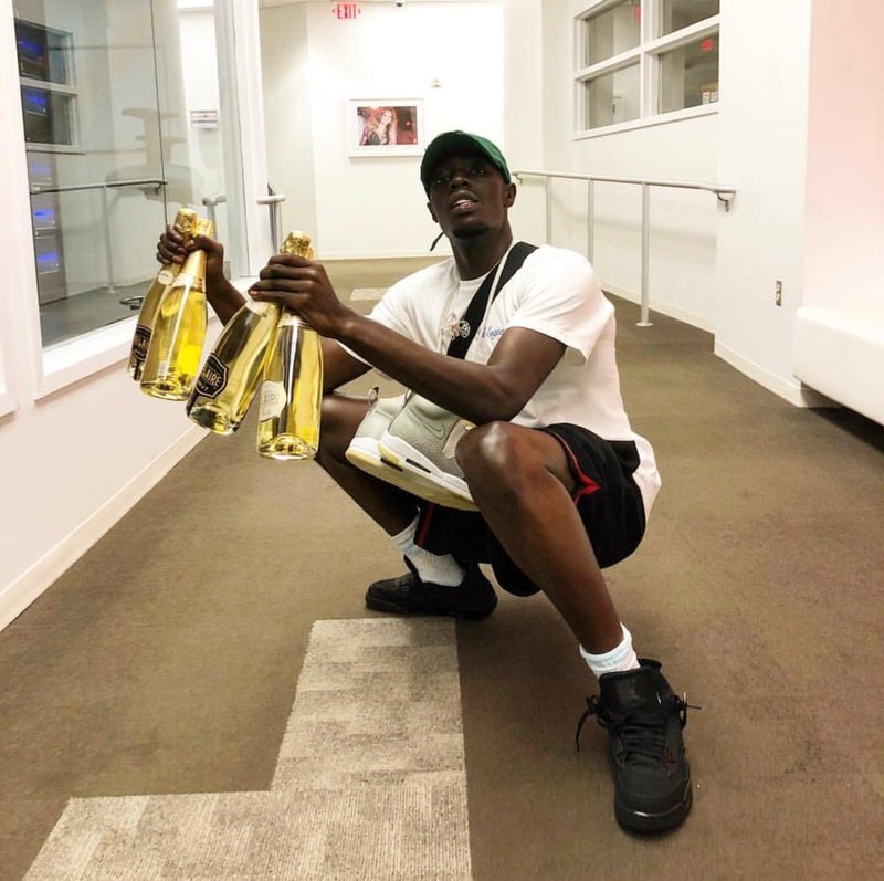 Celebrating the pick-up of his latest Jordan 4s that none of us have.