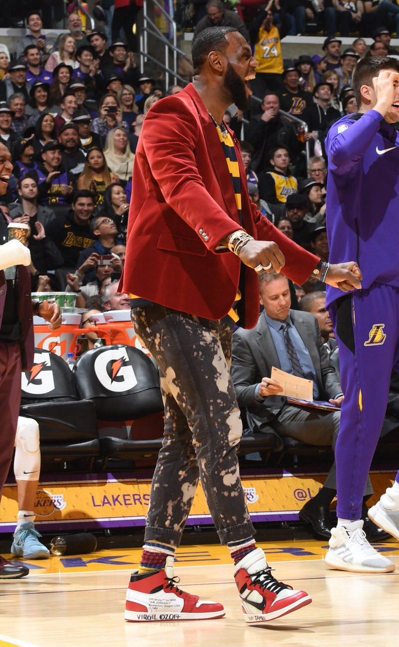 LeBron adopts LA's punk rock personality with acid wash Gucci jeans, contrasting striped shirts, vibrant socks, and OFF-WHITE x Jordan 1 "Chicagos."