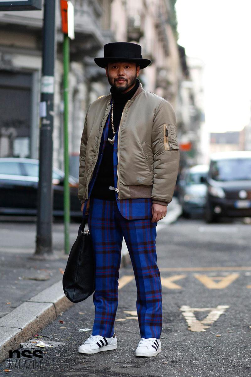 A neutral bomber jacket and a classic pair of Superstars really offset the look of a vibrant pair of plaid pants.