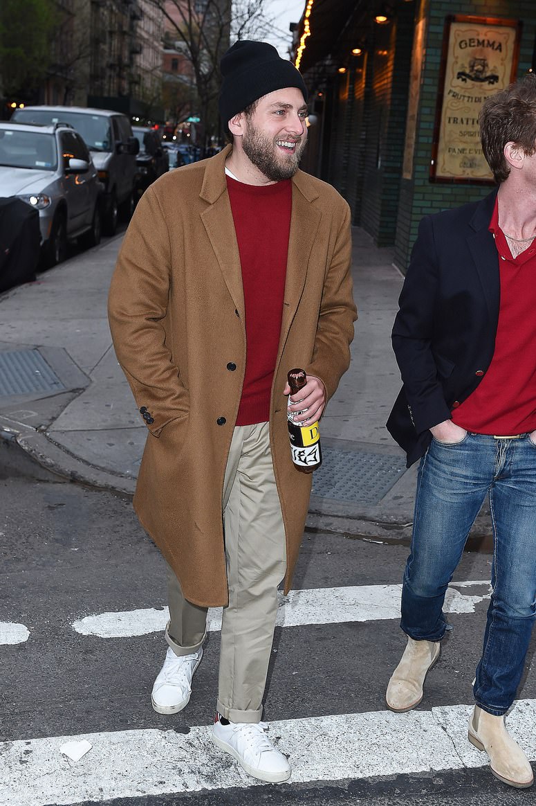 Pairing earthy tones with a long overcoat and a subtle hit of red underneath are the essentials to a sophisticated winter wardrobe. Hill's Saint Laurent sneakers add in a punk persona.