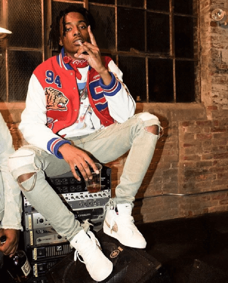 Playboi Carti styles the Supreme x Nike SB Blazer with a letterman look and ripped skinny jeans.