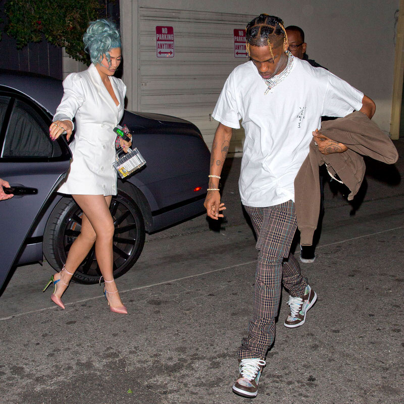 Kylie Jenner with Travis Scott, wearing the FLOM (For Love or Money) SB Dunk Highs.