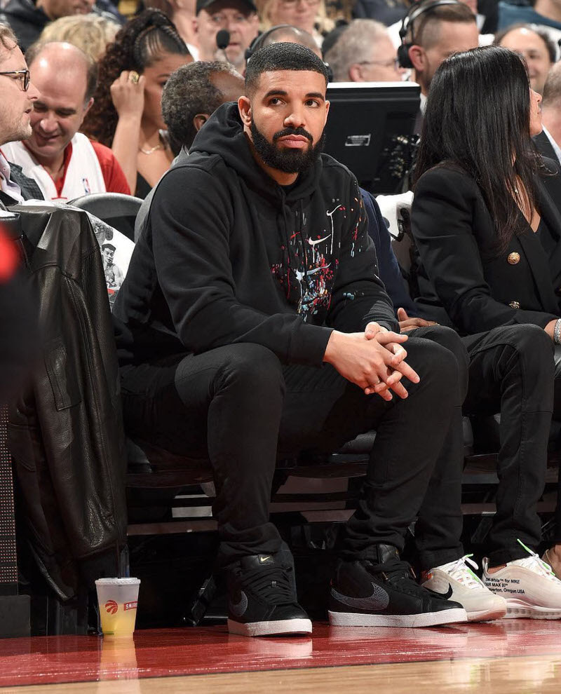 Drake wears graphic Nike sweatshirt and skinny jeans with the Supreme x Nike SB Blazer (photo by Ron Turenne).