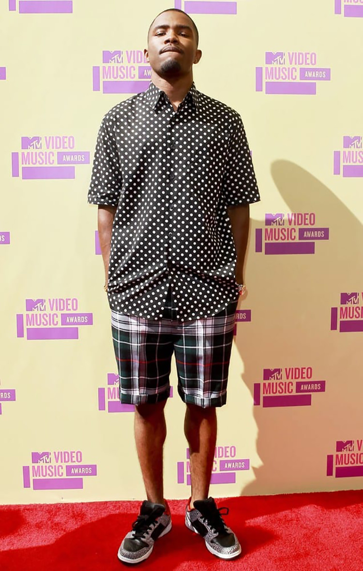 Frank Ocean gets pattern heavy with his polka-dot shirt, plaid shorts, and Supreme x Nike SB Dunk Low.