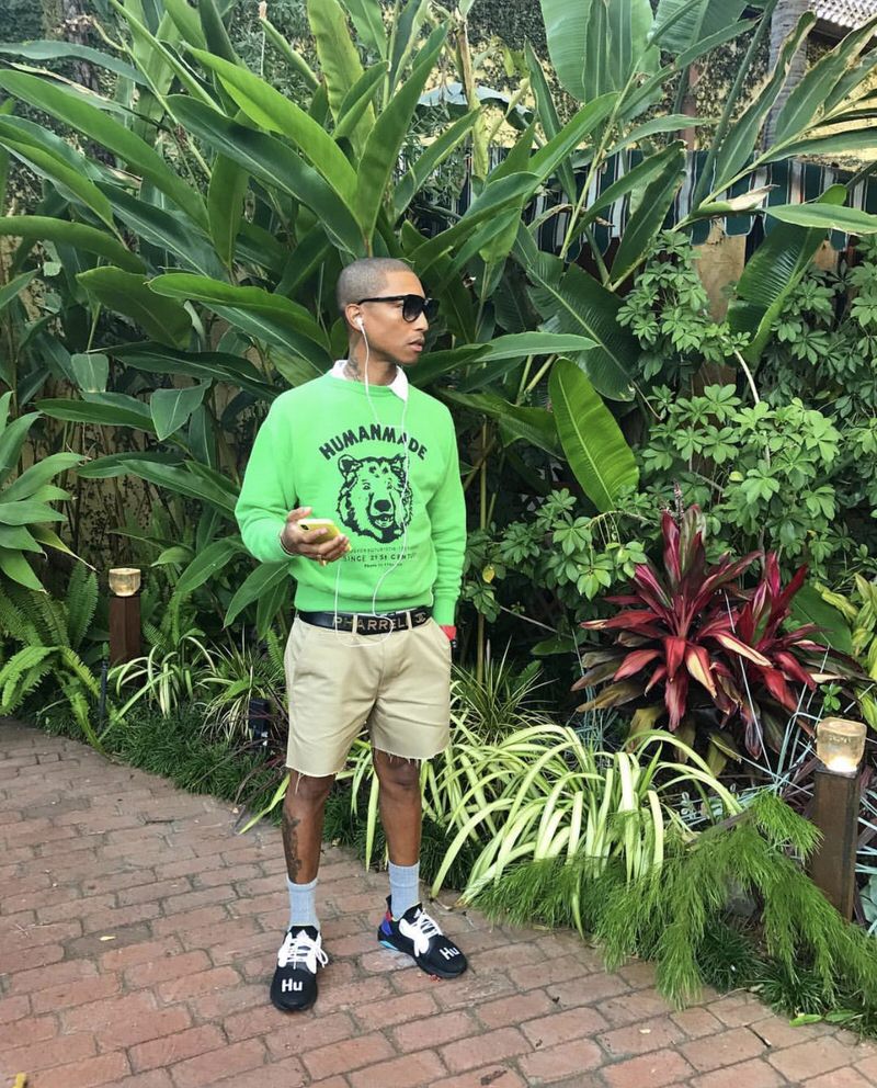 Pharrell pairs a vibrant Human Made crewneck with cutoff pants and adidas Solar Hu Glides.