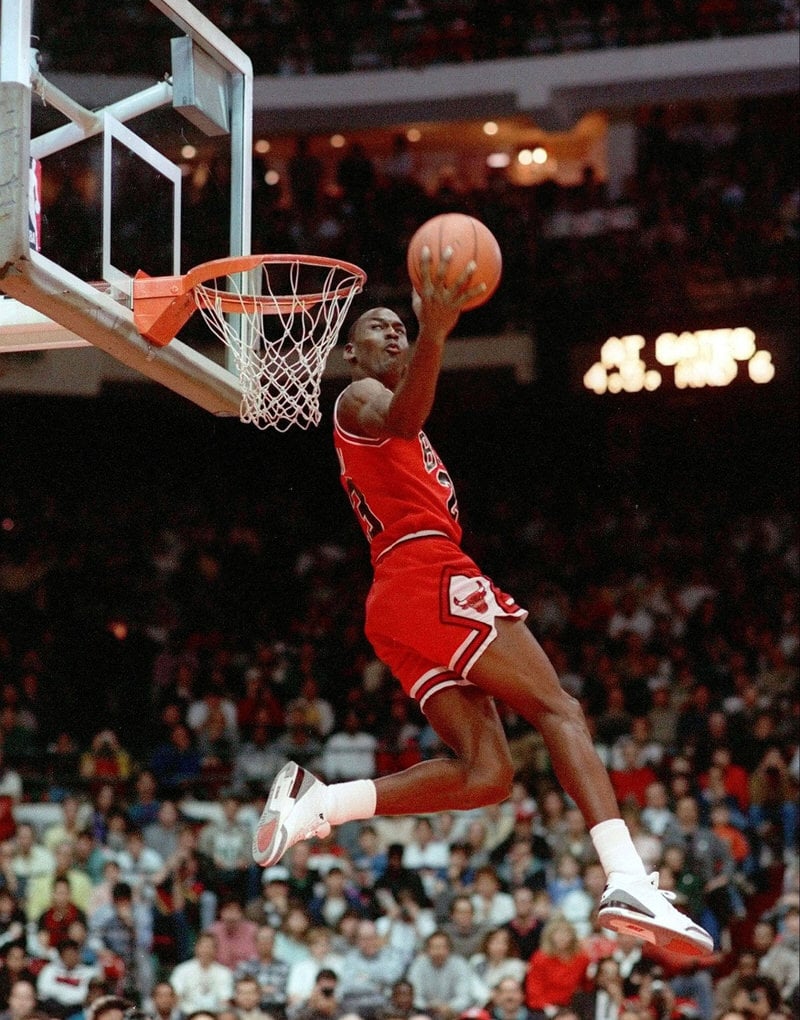 Michael Jordan wearing the Air Jordan 3 White/Cement in 1988 NBA Dunk Contest